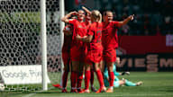 Lea Schüller celebrates with the team after her goal.