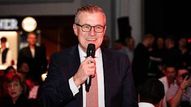 Jan-Christian Dreesen speaks at the banquet after FC Bayern's Champions League match at Manchester United