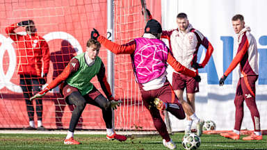Jonas Urbig im Tor erwartet einen Schuss von Serge Gnabry im Abschlusstraining des FC Bayern vor dem Rückspiel gegen Celtic Glasgow.