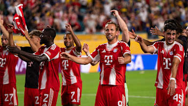 Harry Kane and other players celebrate with the fans after the win over Boca Juniors