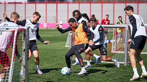 Jamal Musiala shields the ball against several opponents during FC Bayern's training session ahead of their visit to FC Augsburg