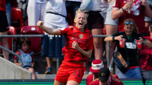 Lea Schüller jumps in the air in celebration after her goal.