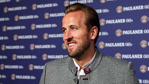 Harry Kane trägt einen Jancker und lacht