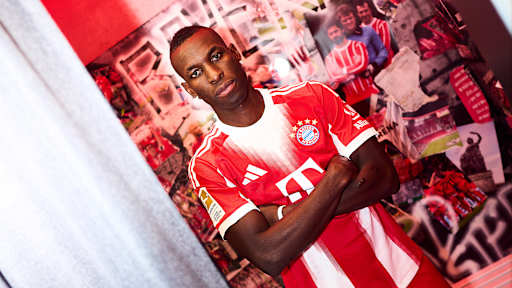 Nicolas Jackson trägt ein FC Bayern Trikot und hat die Arme verschränkt