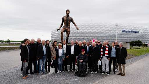 Gruppenfoto unter anderem mit Heidi Beckenbauer, Herbert Hainer und Uli Hoeneß vor dem Denkmal von Franz Beckenbauer