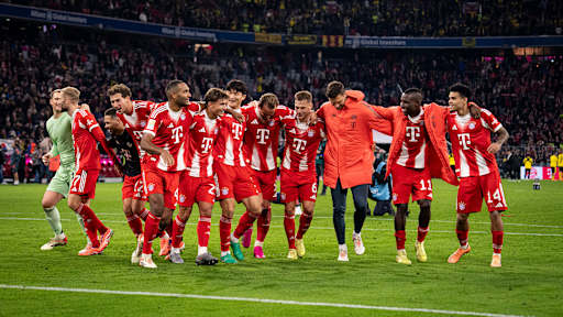 FC Bayern players celebrate with the fans at the Allianz Arena following the win against Dortmund