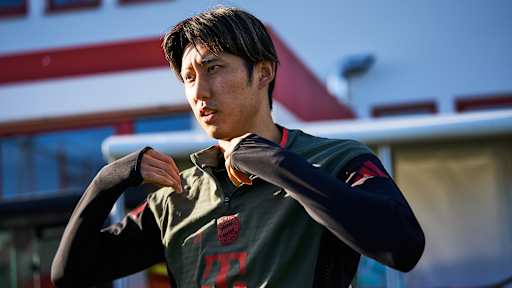 Hiroki Ito steift seinen Pullover über beim Weg auf den Trainingsplatz