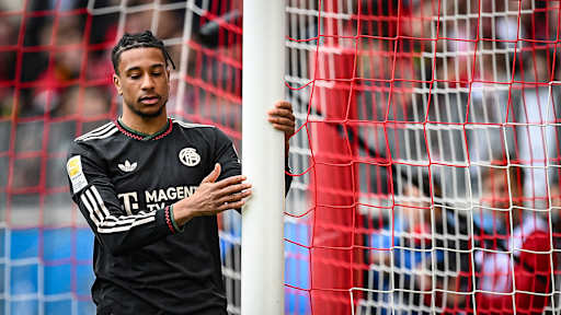 Michael Olise hat den Pfosten in der Hand während des Gastspiels des FC Bayern in der Bundesliga beim SC Freiburg