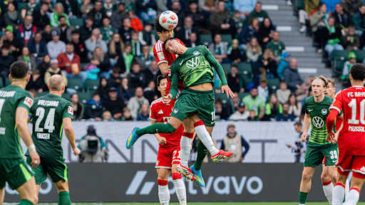 Minjae Kim im Kopfballduell mit Adam Daghim im Bundesliga-Spiel des FC Bayern beim VfL Wolfsburg