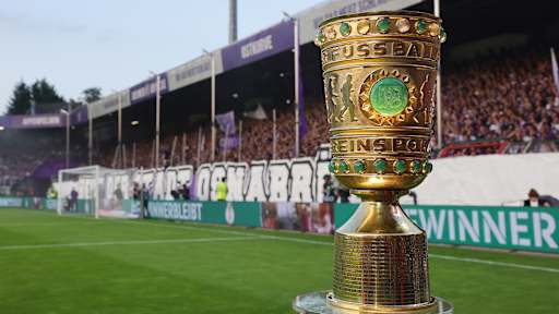 The DFB Cup on the pitch in front of a stand at the Stadion an der Bremer Brücke in Osnabrück