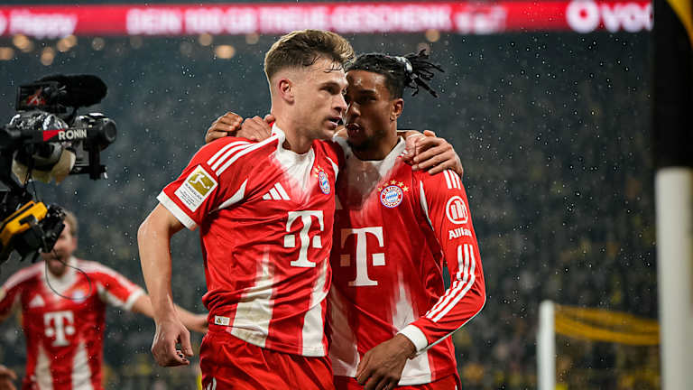 Joshua Kimmich and Michael Olise celebrate during FC Bayern's top-of-the-table clash at Borussia Dortmund