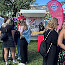 SUPERBLOOM festivalgoers in front of FC Bayern's ‘Red against Racism’ stand
