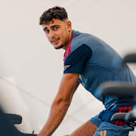 Aleksandar Pavlovic sitzt auf dem Ergometer und schaut in die Kamera