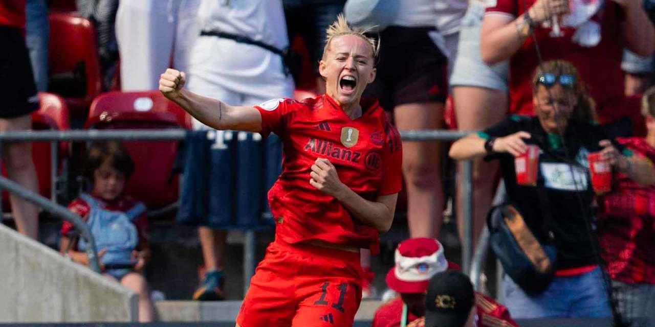 Lea Schüller jumps in the air in celebration after her goal.