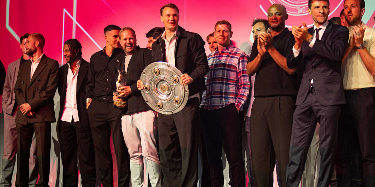 The FC Bayern men's team celebrate with their trophies
