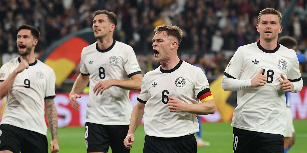 Joshua Kimmich celebrates with his team-mates after a goal for Germany.