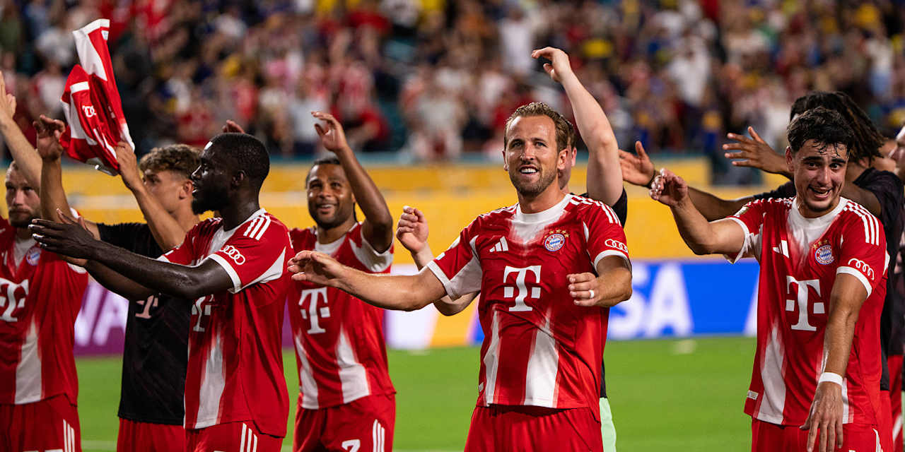 Harry Kane and other players celebrate with the fans after the win over Boca Juniors