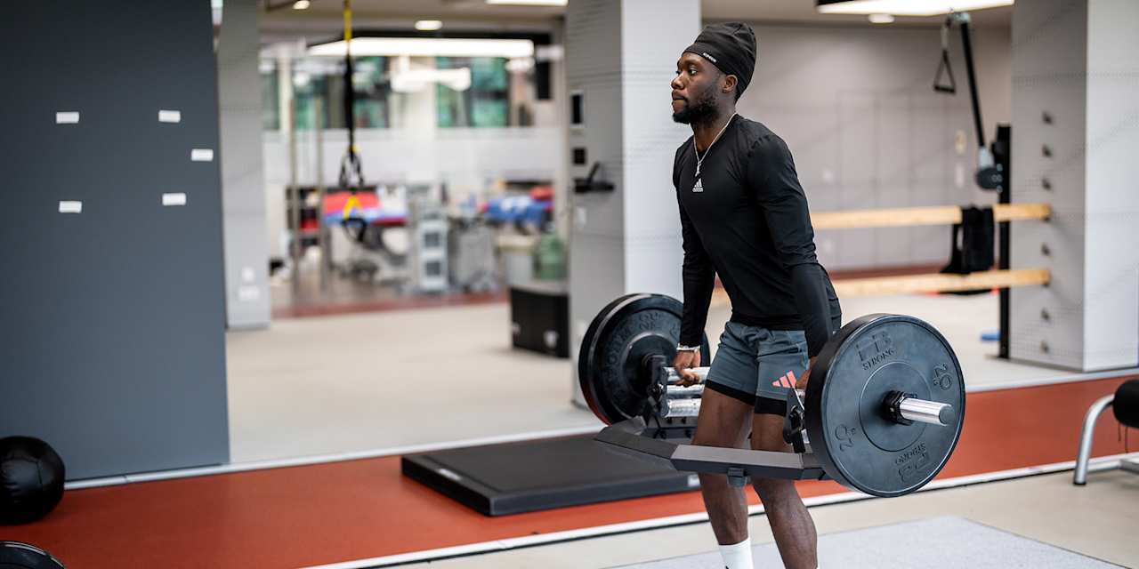 Alphonso Davies lifts a dumbbell in FC Bayern rehab training