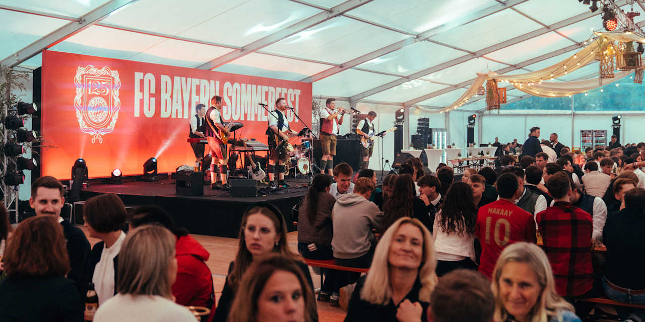 A look into the beer tent with the band on the stage and guests on the benches