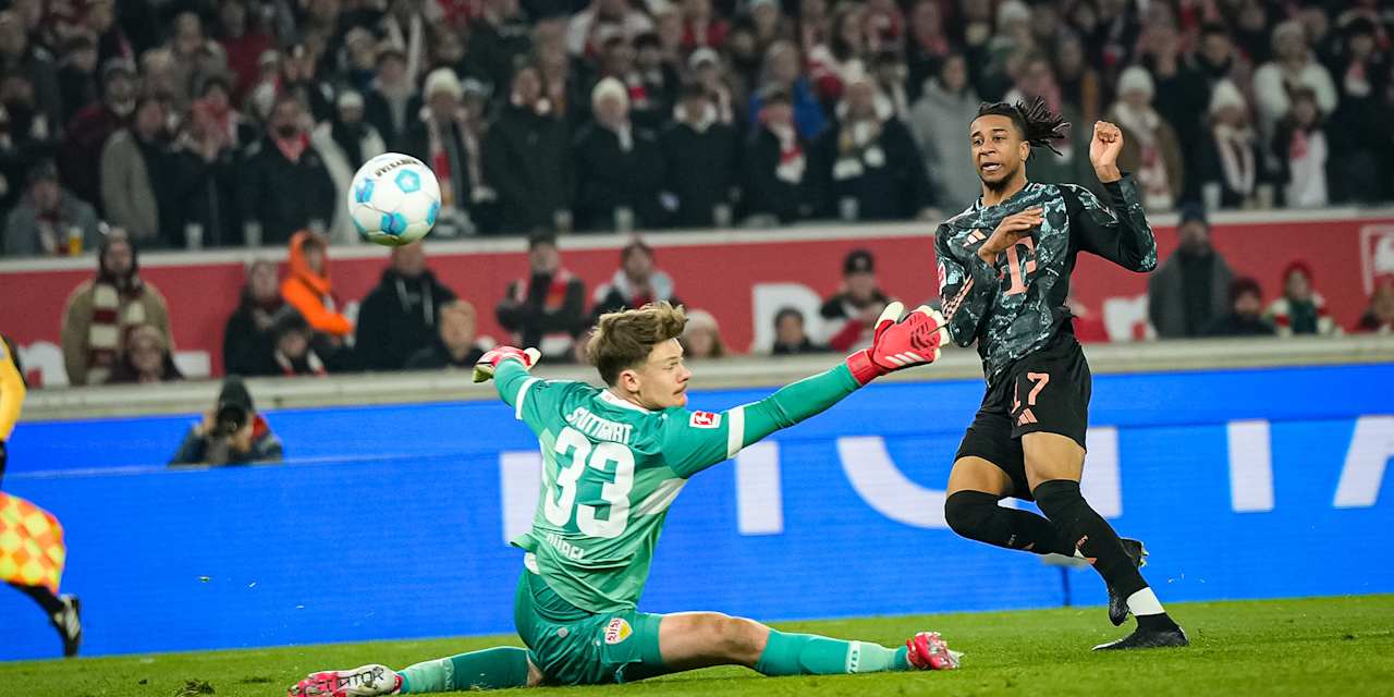 Michael Olise scores against Alexander Nübel in the Bundesliga match at VfB Stuttgart