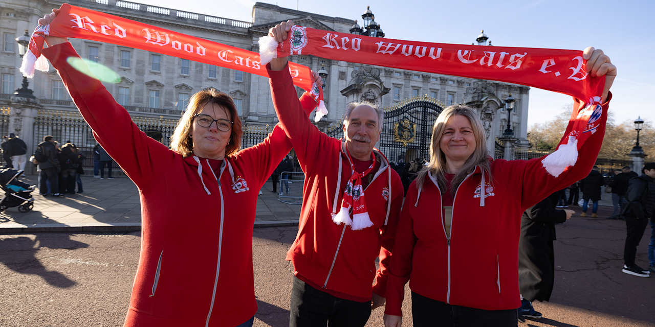 Fans des FC Bayern halten vor dem Buckingham Palace Schals in die Höhe