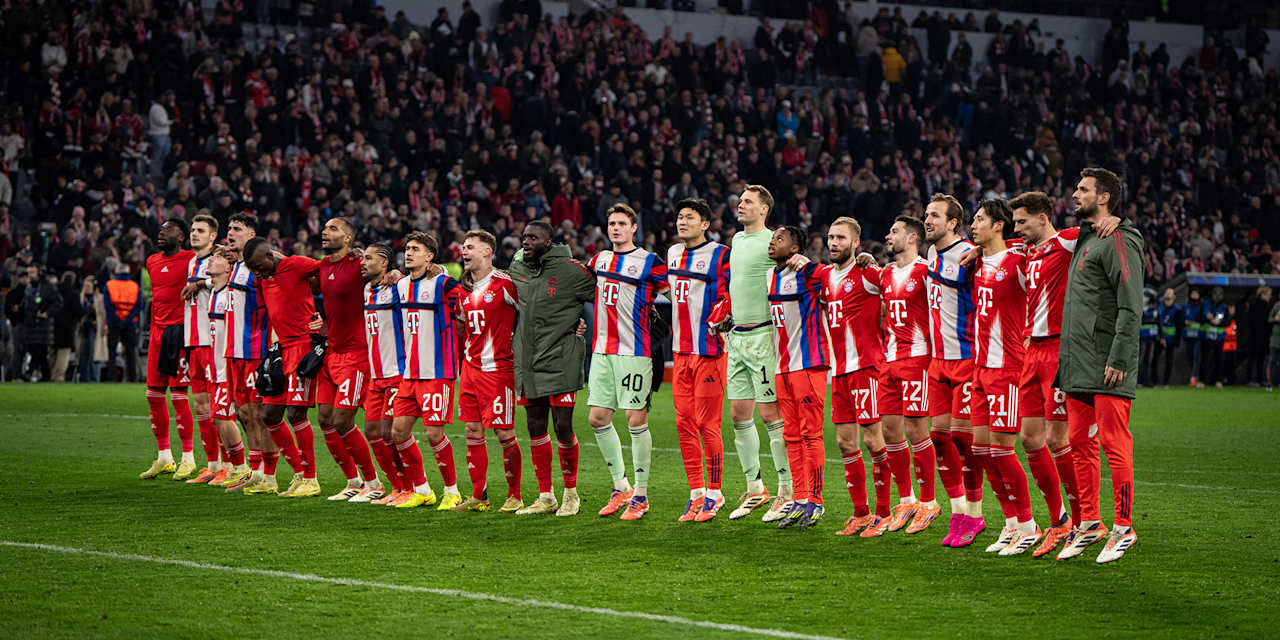 FC Bayern players celebrating with an FC Bayern fan after a match at the Allianz Arena.