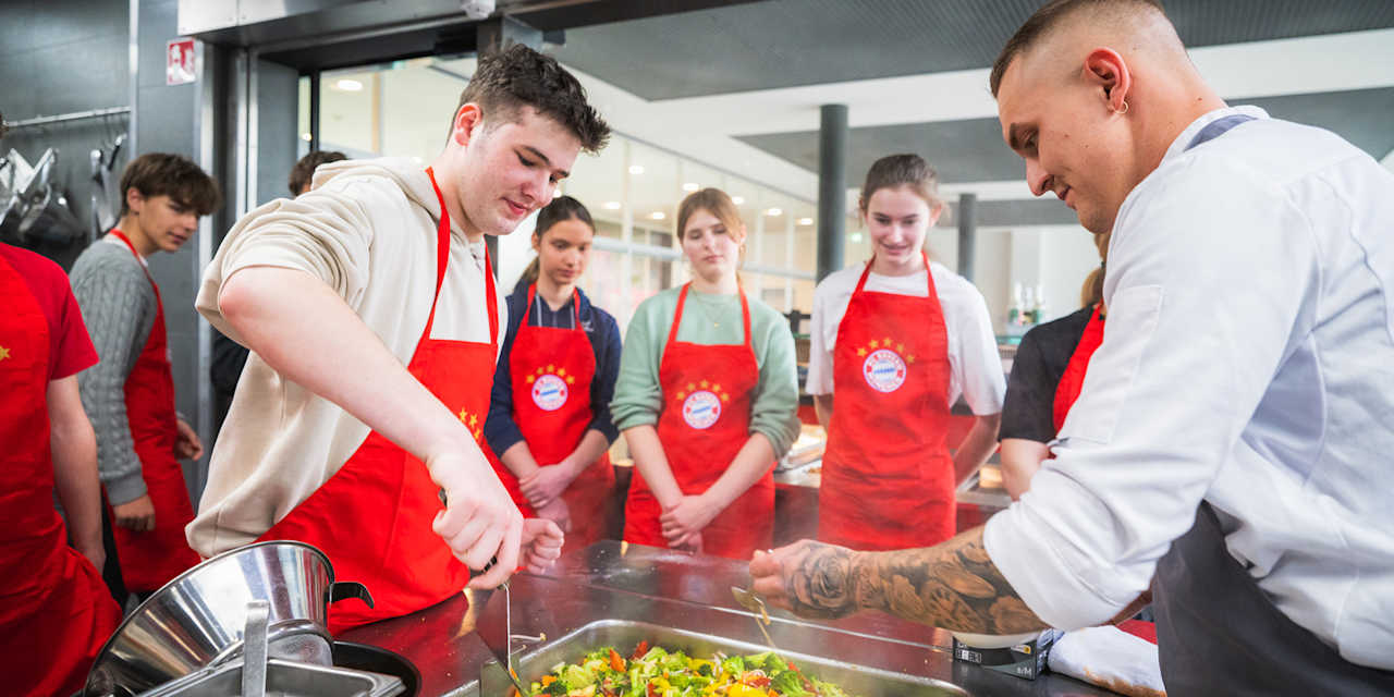 Jugendliche beim Kochen beim Ernährungsworkshop des FC Bayern