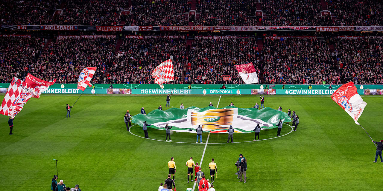 The teams of FC Bayern and RB Leipzig walk out at the Allianz Arena for a DFB Cup quarter-final