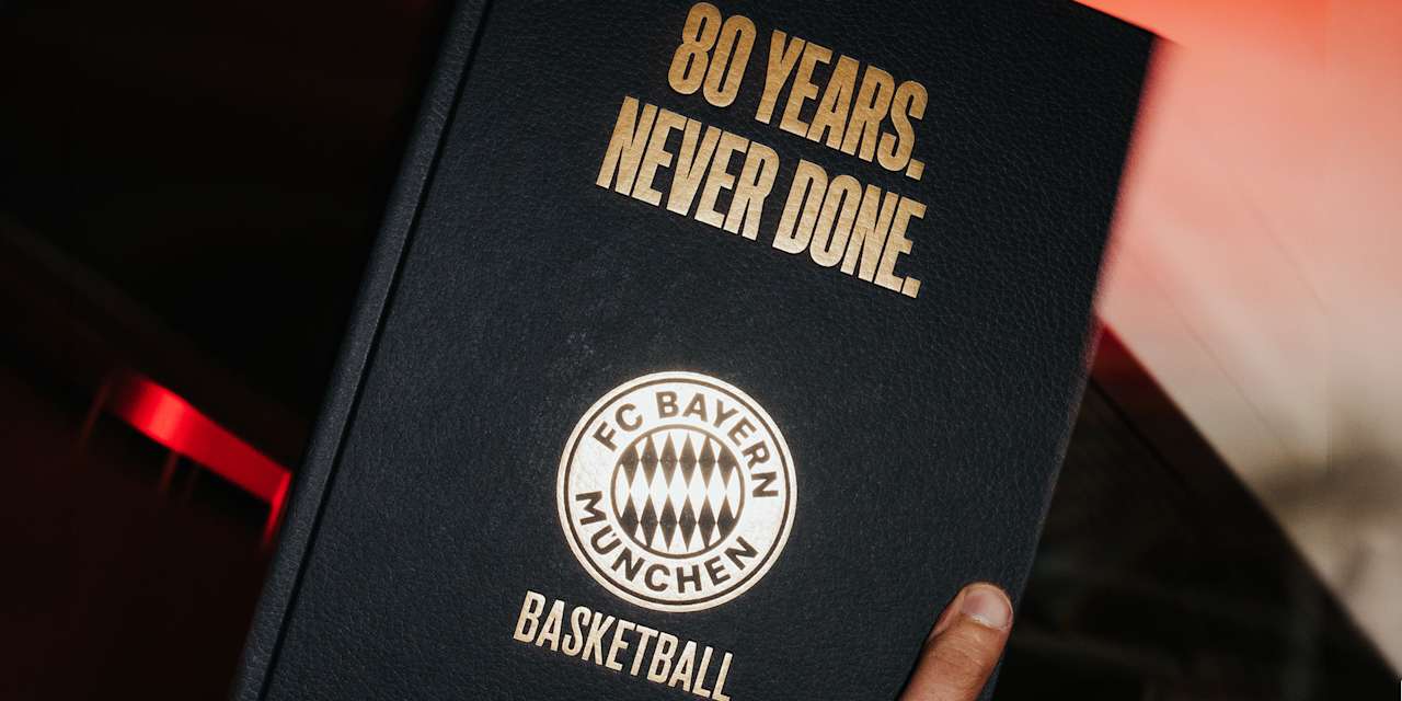 Adrian Sarmiento holds the book commemorating the FCBB's 80th anniversary
