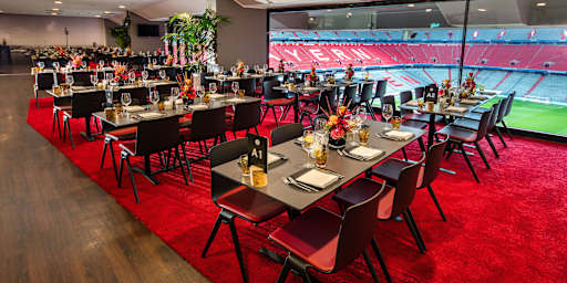 Event box – low tables in front of glass front with view into the stadium interior