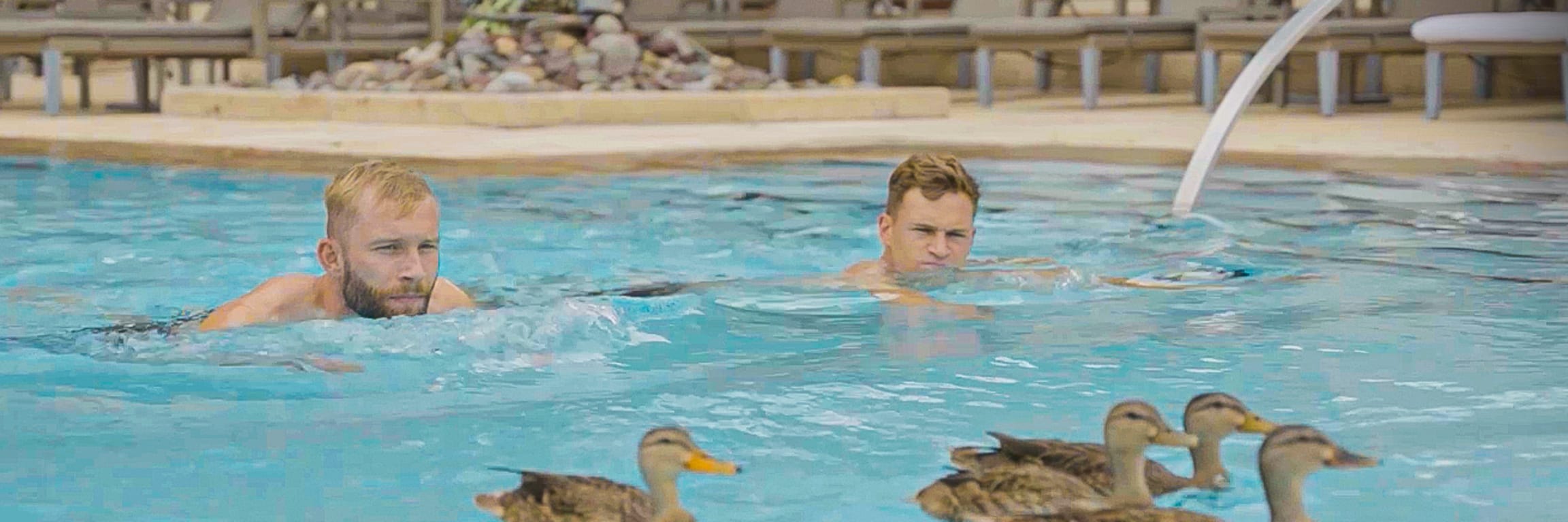 Konrad Laimer and Joshua Kimmich swimming in the pool with ducks in Orlando