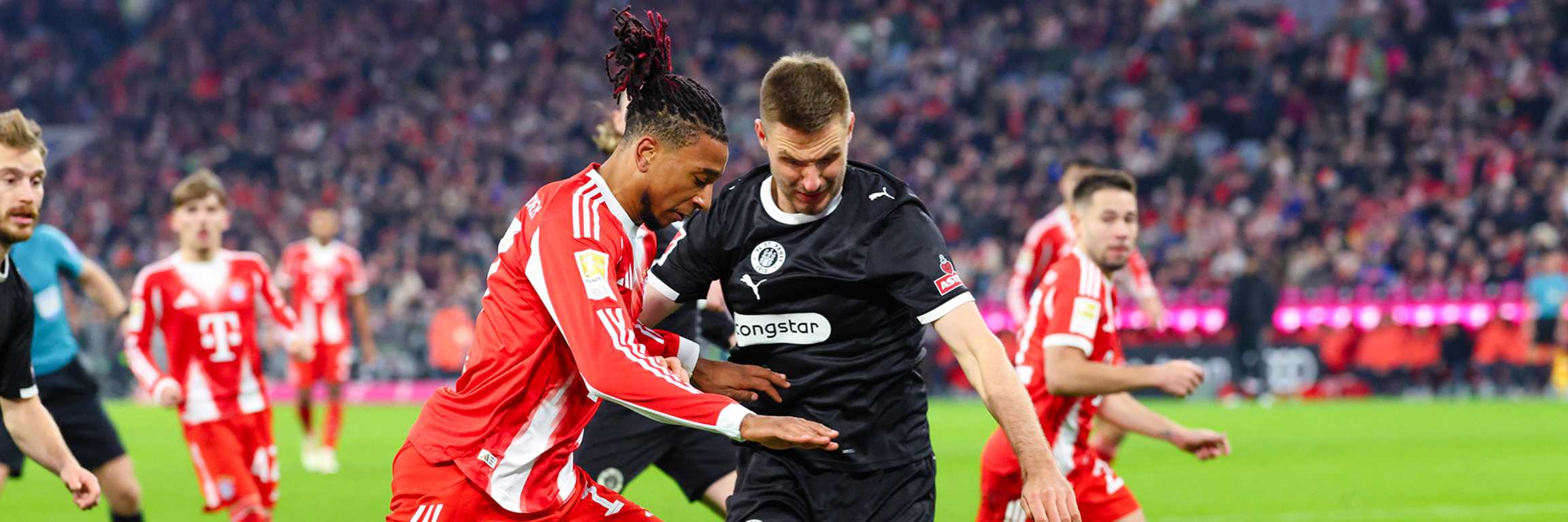 Michael Olise dribbelt mit dem Ball im Bundesliga-Heimspiel des FC Bayern gegen den FC St. Pauli.