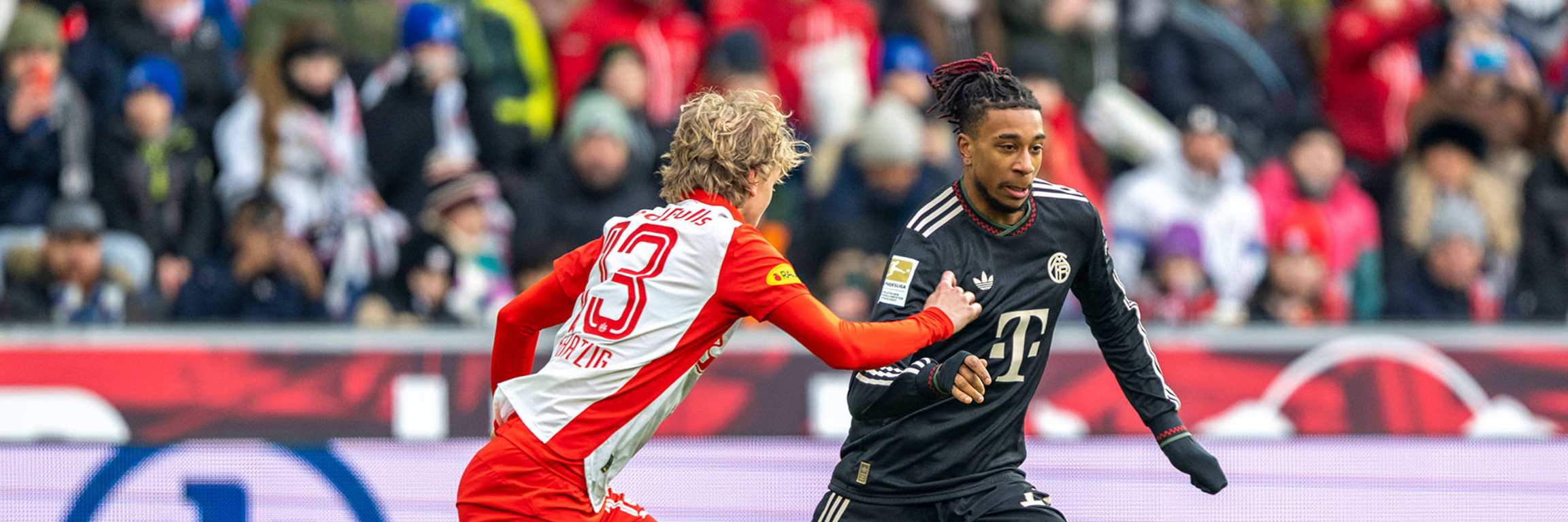Michael Olise im Zweikampf mit Frans Krätzig im Testspiel des FC Bayern bei Red Bull Salzburg