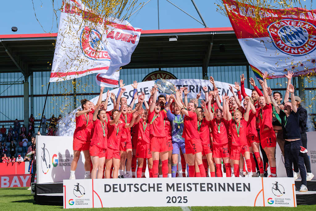 FC Bayern Women being presented with the Meisterschale and hoisting it into the air.