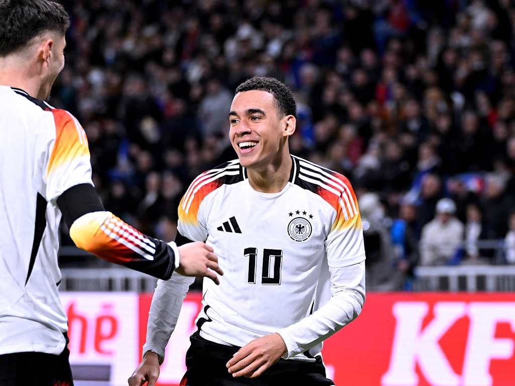 Jamal Musiala celebrates with goalscorer Kai Havertz after Germany's second goal against France.