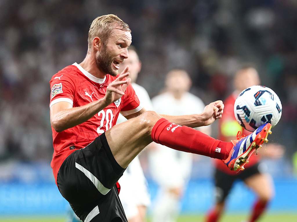 Konrad Laimer brings the ball down.