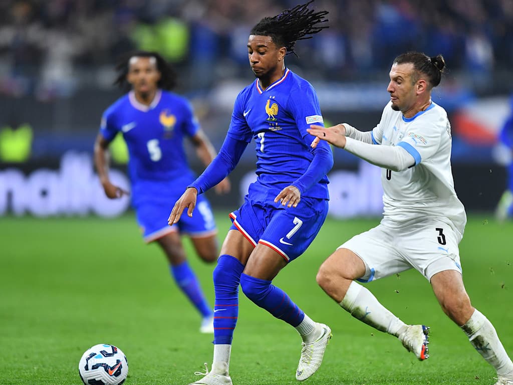 Michael Olise tussles with his opponent in the game between France and Israel