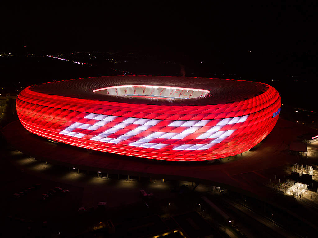 The Munich Allianz Arena lights up in red at New Year with the lettering 2025 on the façade.