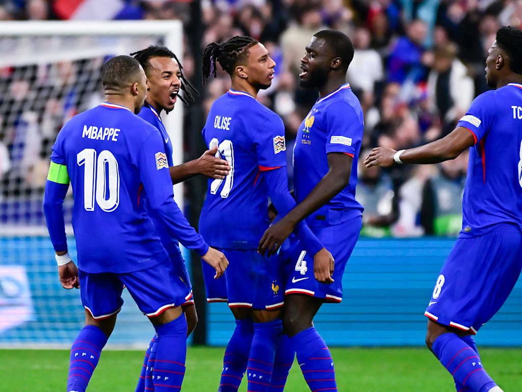 Michael Olise and Dayot Upamecano celebrate a goal with their teammates during the international between France and Croatia.