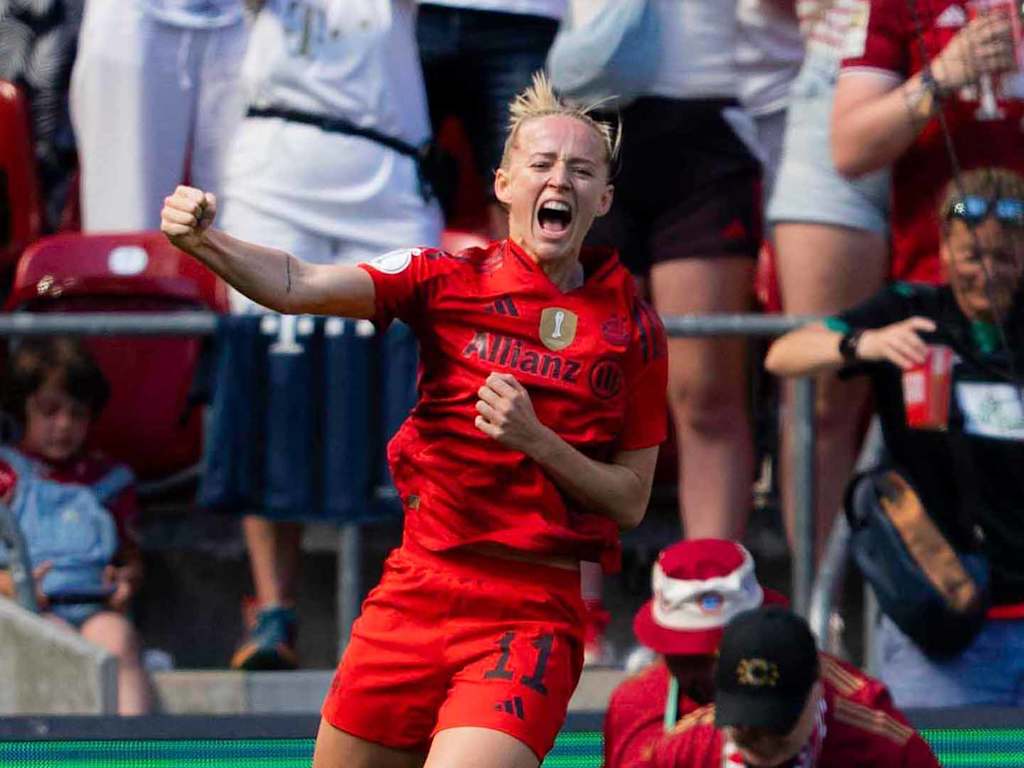 Lea Schüller jumps in the air in celebration after her goal.