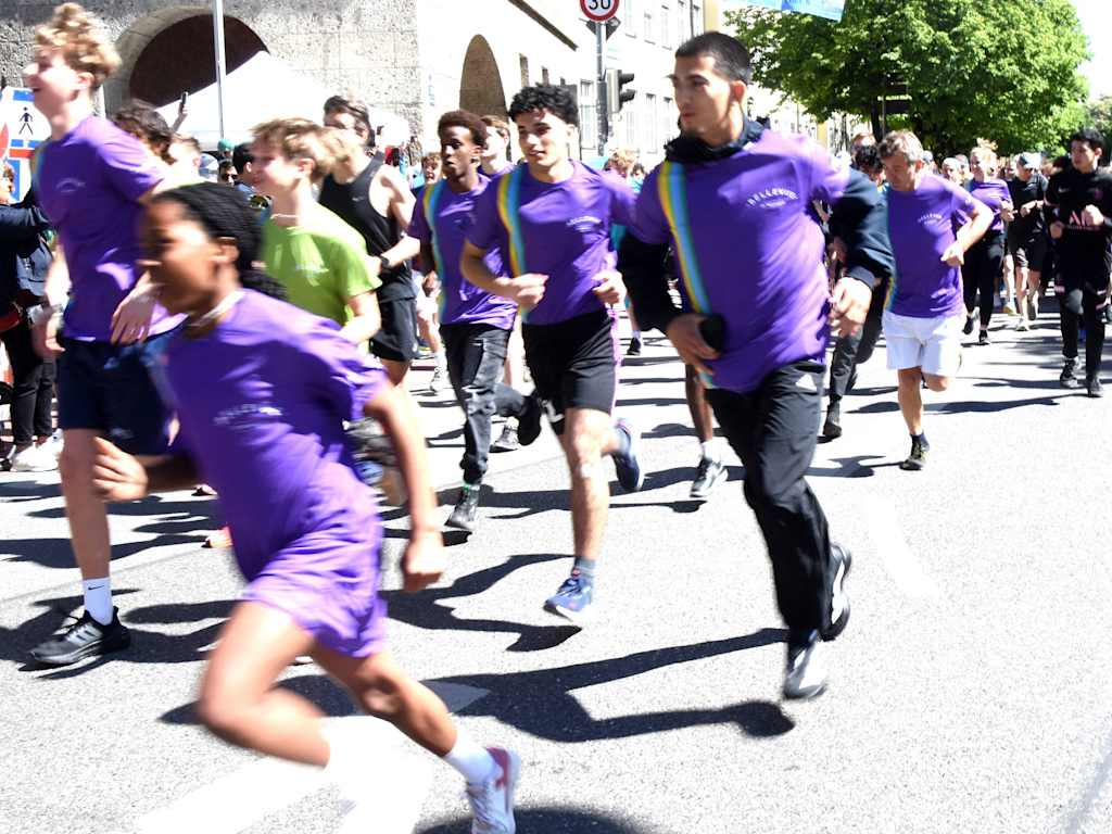 Participants in the Giro di Monaco jog through Munich