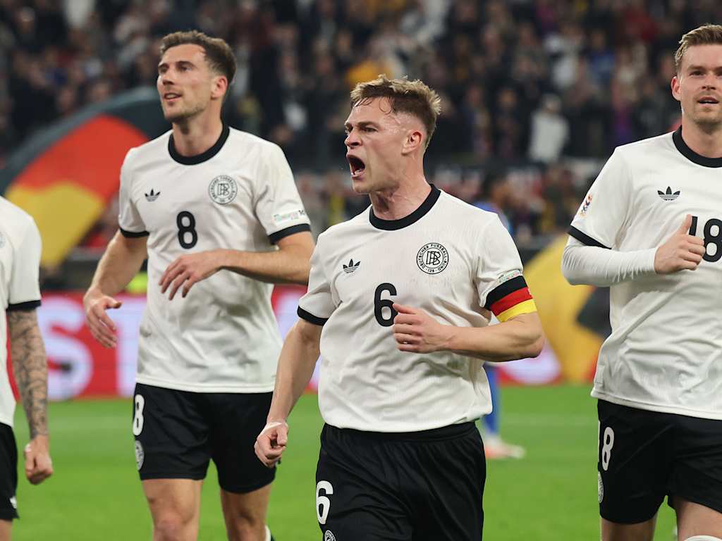 Joshua Kimmich celebrates with his team-mates after a goal for Germany.