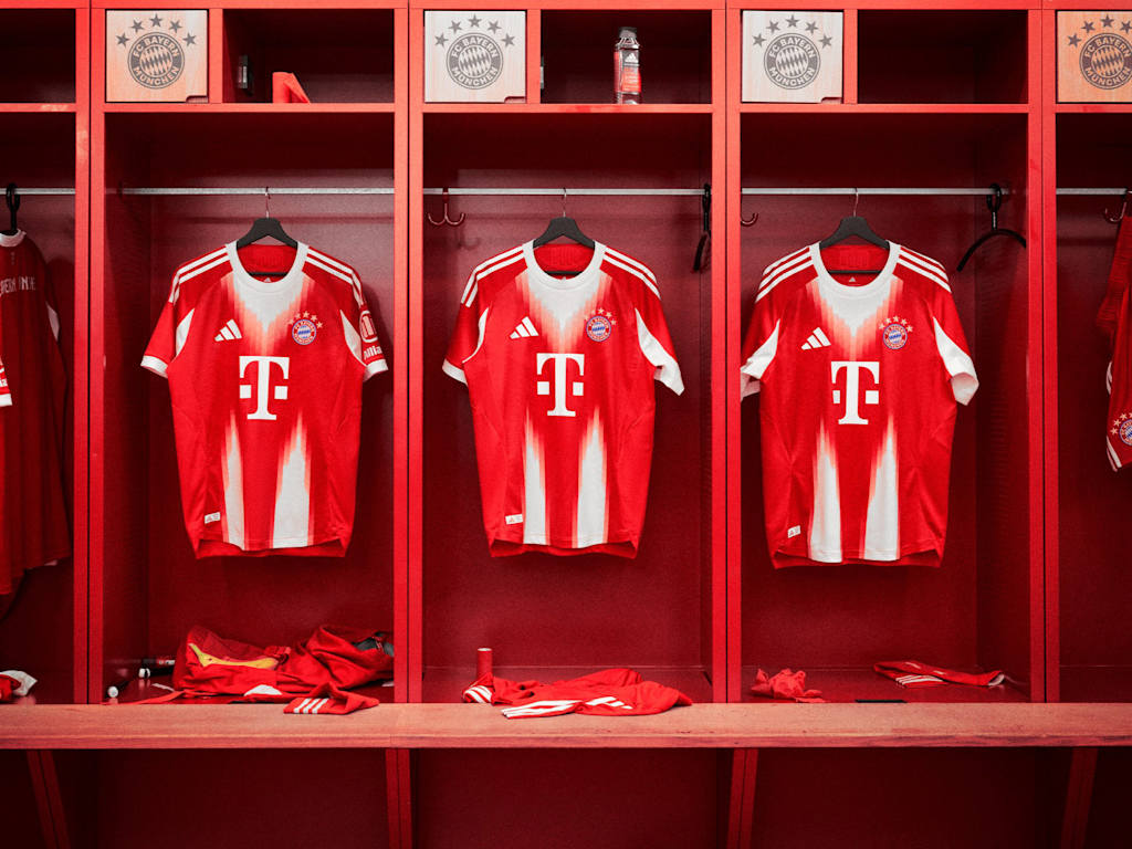 FC Bayern's new home jersey in red and white with a stylised M hanging in the dressing room