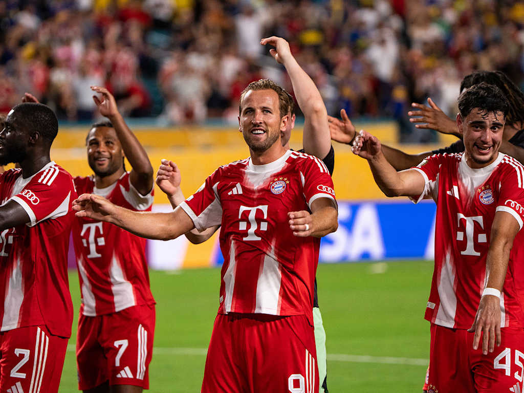 Harry Kane and other players celebrate with the fans after the win over Boca Juniors