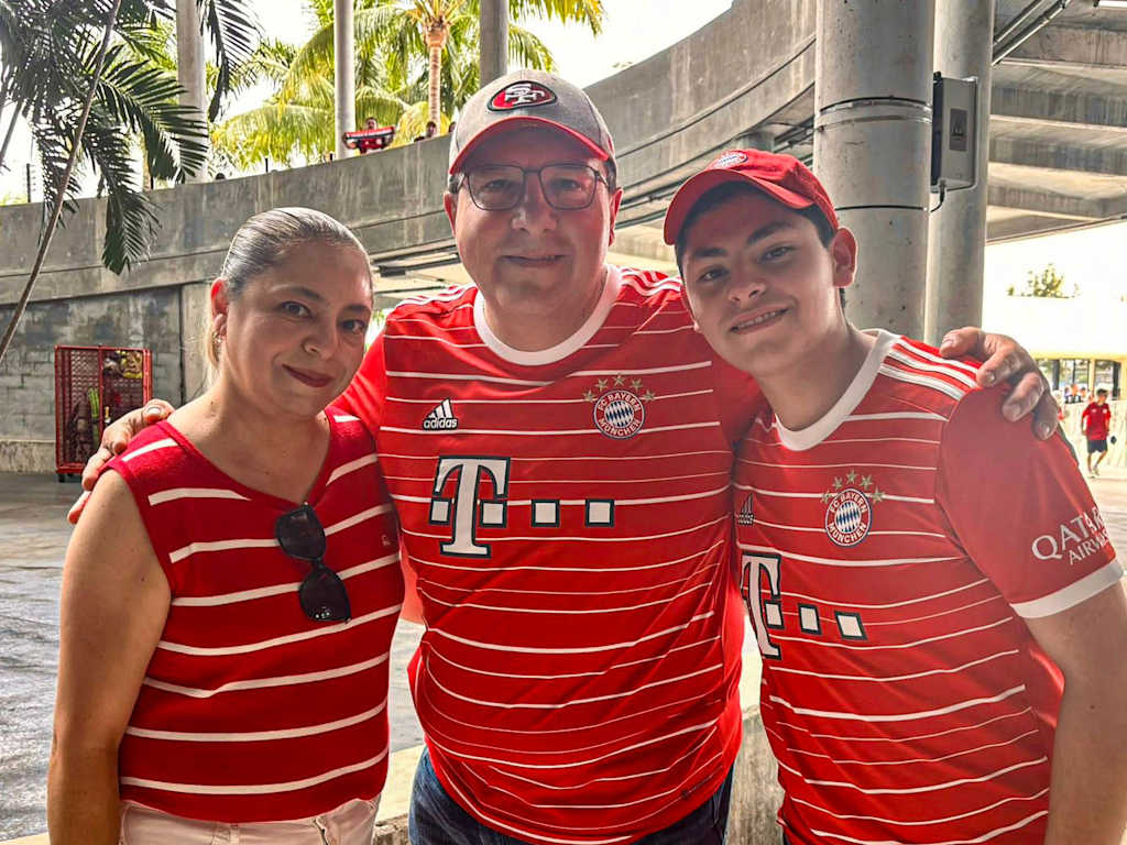 Mother, father and son stand together arm in arm