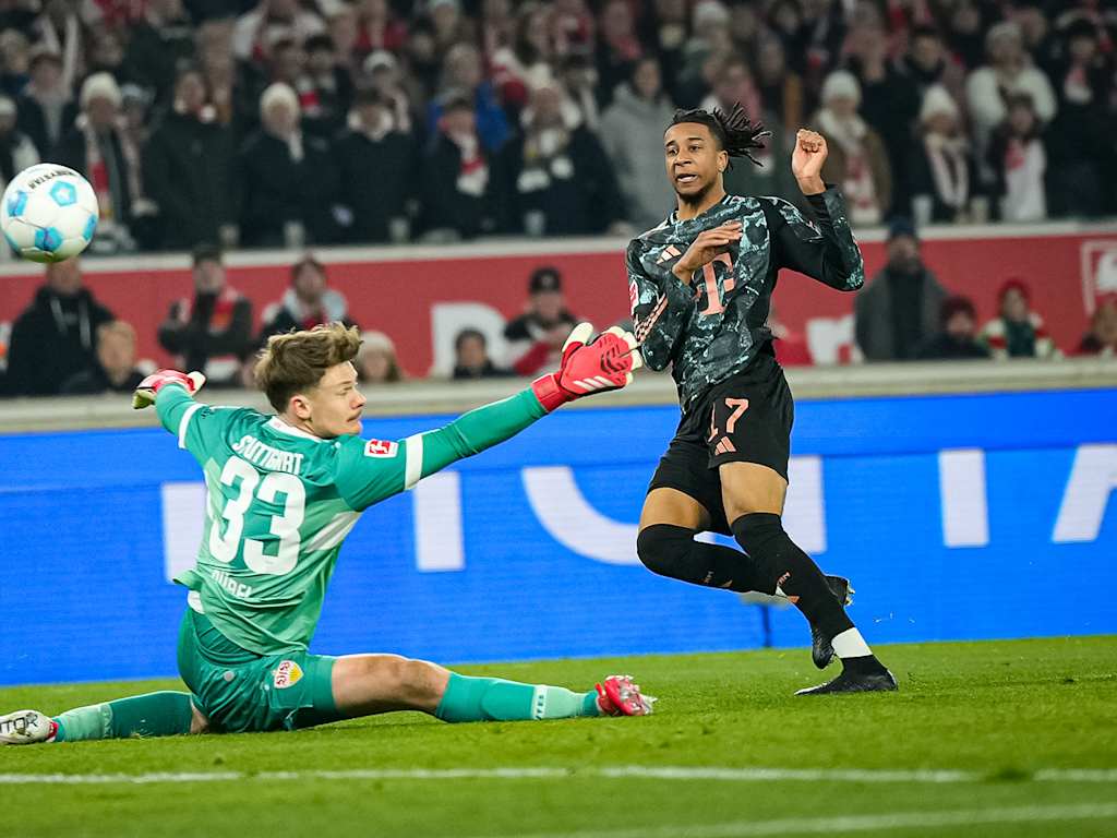 Michael Olise scores against Alexander Nübel in the Bundesliga match at VfB Stuttgart
