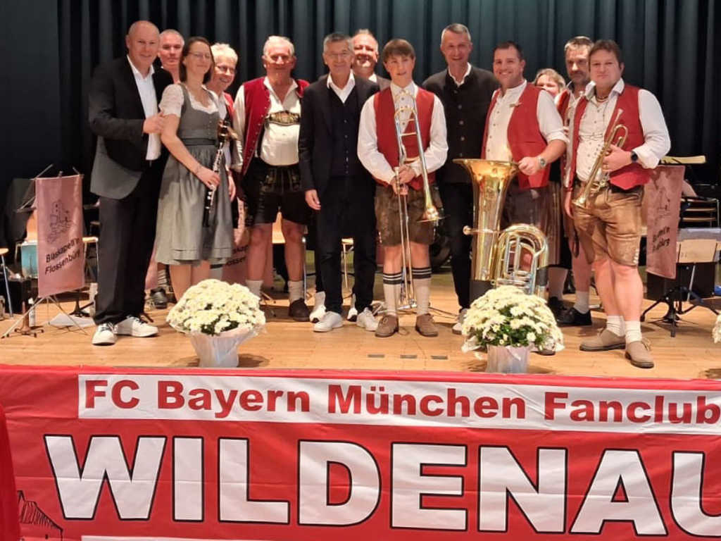 President Herbert Hainer with fans and brass band at the fan club anniversary celebration