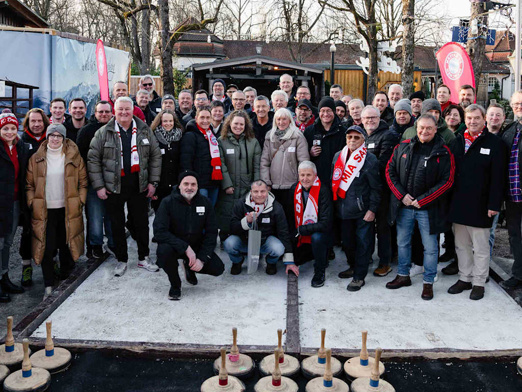 Gruppenbild der Teilnehmer am FC Bayern-Eisstockschießen am Nockherberg mit Präsident Herbert Hainer im Zentrum.
