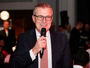 Jan-Christian Dreesen speaks at the banquet after FC Bayern's Champions League match at Manchester United