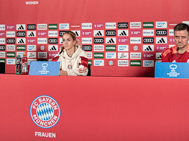 Giulia Gwinn and Alex Straus sit side by side on the podium during the press conference